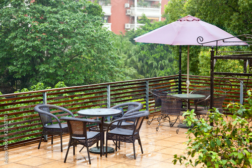 Photo: Patio rattan chairs and table in raining Patio rattan chairs and table in raining