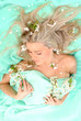 sensual woman is lying with white flowers