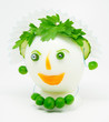 Egg garnished with parsley, cucumber, carrots and green peas