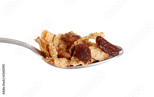 Photo: isolated spoonful of bran and raisin cereal isolated spoonful of bran and raisin cereal