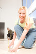 Happy woman measuring the floor