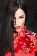 pretty woman in red Cheongsam on dark background pretty woman in red Cheongsam on dark background