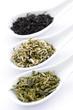 Assortment of dry tea leaves in spoons Assortment of dry tea leaves in spoons