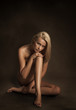 Naked young woman in sensual pose