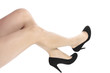 Beautiful woman legs and black heel shoes over white background