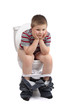 Little boy is sitting on toilet
