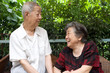a senior couple look at each other.