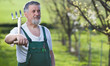 Portrait of a senior man gardening in his garden