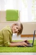 Photos : Smiling woman with computer at home