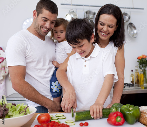 Photo: Happy young family cooking together Happy young family cooking together