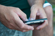 Hands of Man Texting on Smartphone Hands of Man Texting on Smartphone