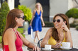 Three Beautiful Young Women Having Coffee With Shopping Bags