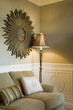 Floor Lamp and Starburst Mirror in Corner of Living Room