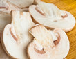 mushrooms slices close-up on wooden cutting board