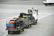Airport. Luggage traffic on an electromobile to the plane Airport. Luggage traffic on an electromobile to the plane
