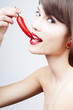 beautiful woman with a chili pepper - close-up beautiful woman with a chili pepper - close-up