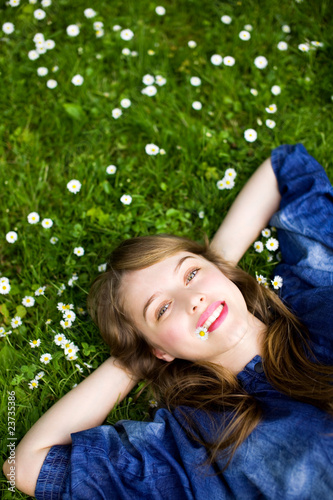 Photo: Young woman lying on the grass Young woman lying on the grass