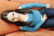 happy woman relax on orange sofa