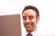 Young professional working on laptop and smiling