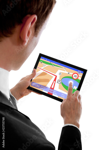Photo: businessman holding a touchpad pc, using the navigation programm businessman holding a touchpad pc, using the navigation programm