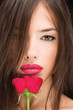 Pretty black hair woman and red rose
