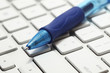 Closeup of a ballpoint pen on top of a computer keyboard Closeup of a ballpoint pen on top of a computer keyboard