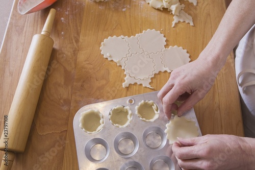 Photo: Person Placing Dough Into Muffin Pan Person Placing Dough Into Muffin Pan