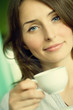 Beautiful Young Woman drinking Coffee