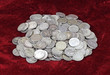 Old silver dimes on a red velvet cloth background