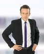 Photo: proud businessman standing in front of camera proud businessman standing in front of camera