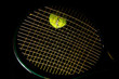 tennis racket and ball on black background