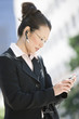 Young businesswoman using mobile outdoors