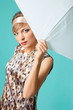 Beautiful fashion girl on the turquoise background with umbrella Beautiful fashion girl on the turquoise background with umbrella