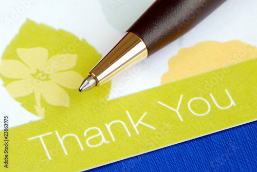 Photo: Write the thank you card isolated on blue Write the thank you card isolated on blue