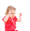 Little serious girl holds a pearl necklace Little serious girl holds a pearl necklace