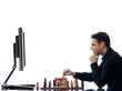 Man playing chess against computer