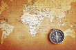 An old brass compass on a Treasure map background An old brass compass on a Treasure map background