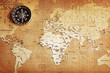 An old brass compass on a Treasure map background An old brass compass on a Treasure map background