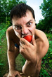 serious man eating tomatoes