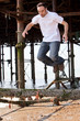 Young man jumping off a pier