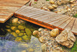 deking with a brige over a river in a beautiful garden