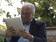 old man using tablet computer e-book reader