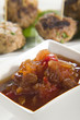 Chutney with meatballs in background
