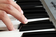 Photo: Closeup of a male hand playing a piano Closeup of a male hand playing a piano