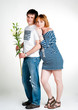 Young beautiful couple expecting a baby with white lilies