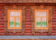 Two carved windows of old wooden house