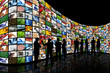 People looking at wall of screens