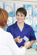 Sales clerk receiving  credit card  for payment, vertical