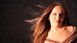 woman with hair fluttering in wind in studio woman with hair fluttering in wind in studio