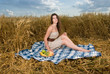 Beautiful slavonic girl on picnic in wheat field